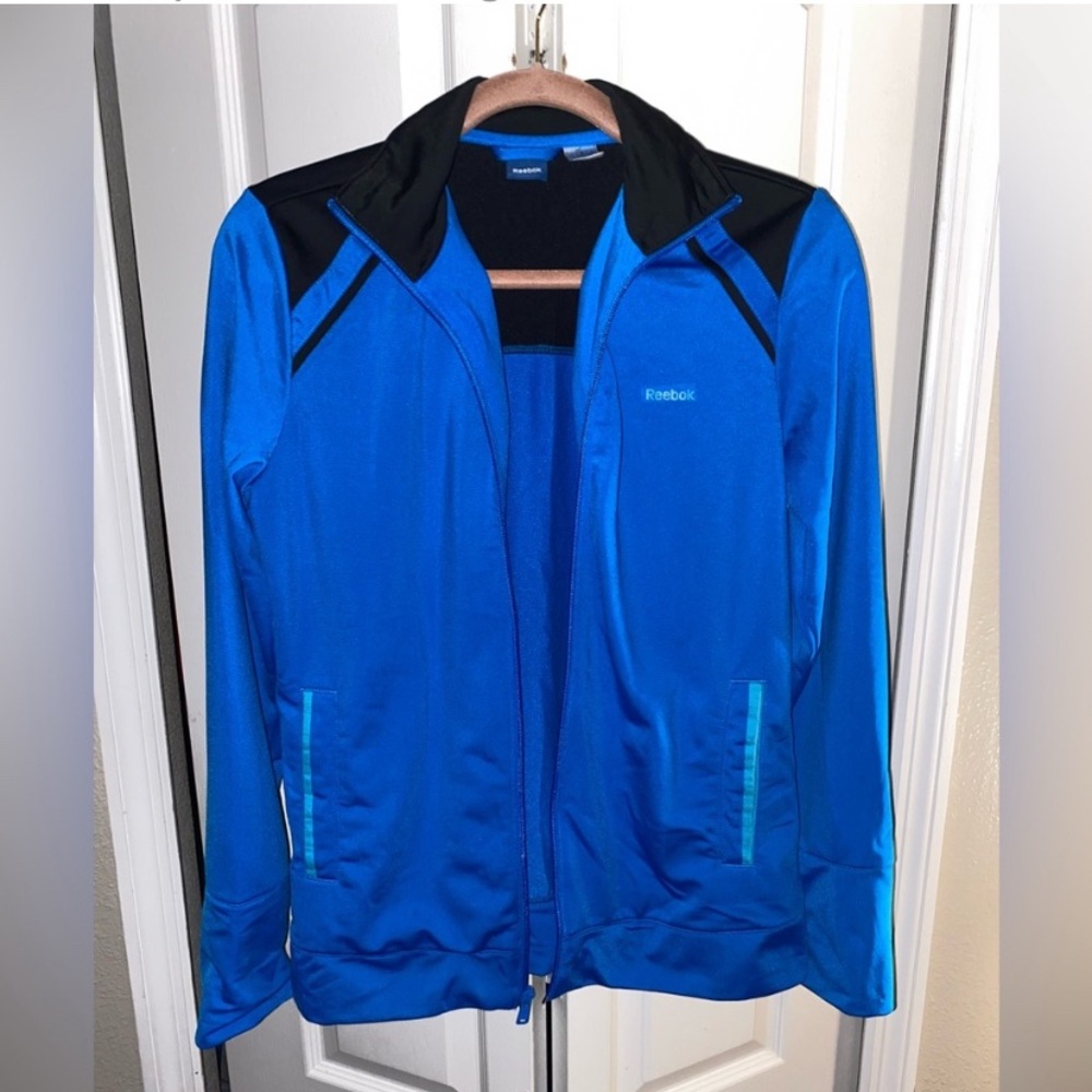 Reebok women’s Blue & Black Utility Jacket Performance is a women’s size medium.